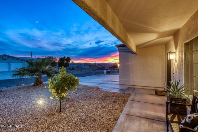 yard at dusk with a patio area