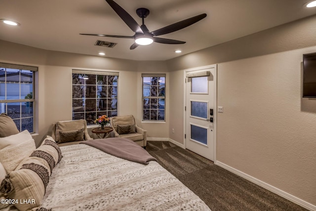 bedroom featuring dark colored carpet and ceiling fan