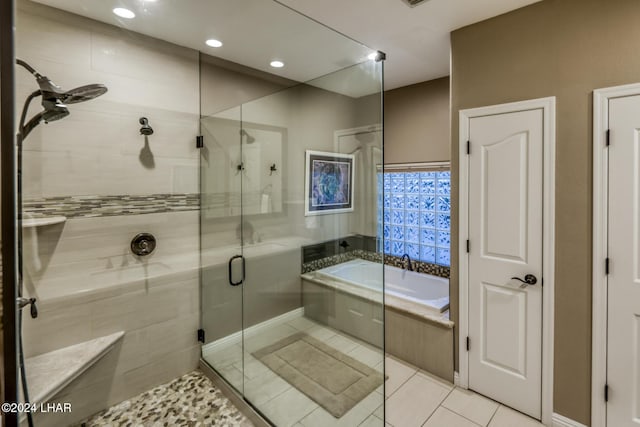 bathroom featuring tile patterned floors and shower with separate bathtub