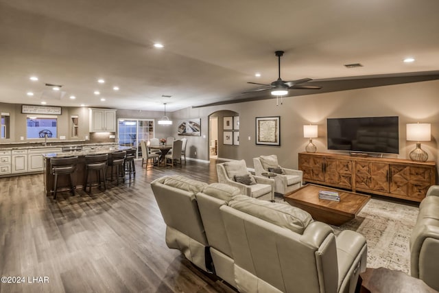 living room with sink, wood-type flooring, and ceiling fan