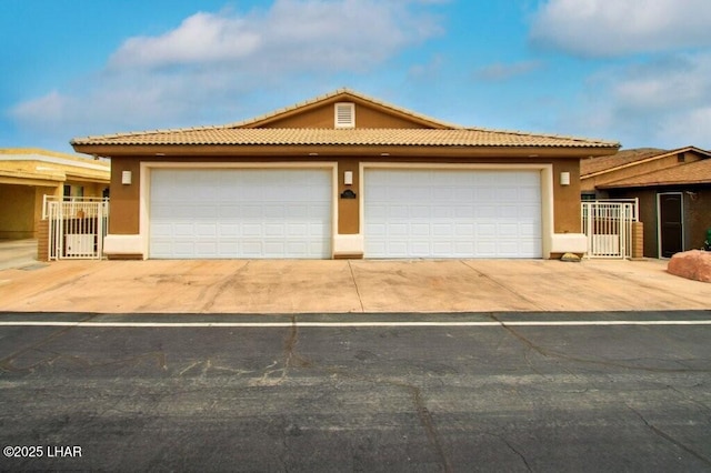 8839 Yaqui Loop, Parker, AZ 85344 - view of front facade with a gate, stucco siding, and a tile roof