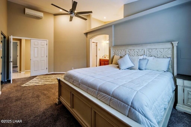8839 Yaqui Loop, Parker, AZ 85344 - bedroom with a wall mounted AC, dark carpet, high vaulted ceiling, and arched walkways