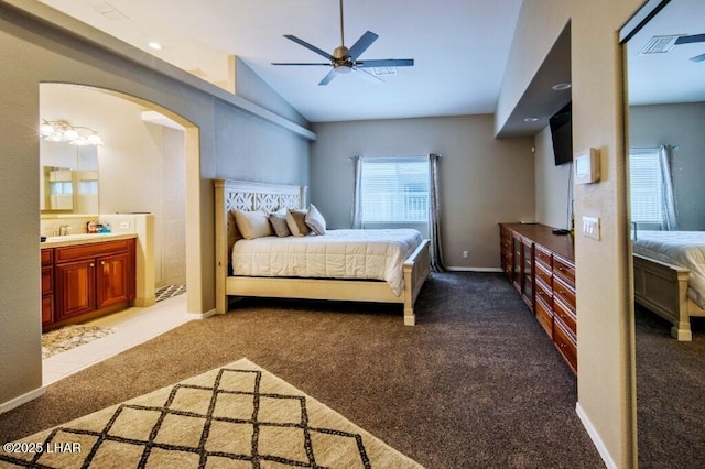 8839 Yaqui Loop, Parker, AZ 85344 - bedroom featuring carpet flooring, vaulted ceiling, a sink, arched walkways, and ensuite bathroom