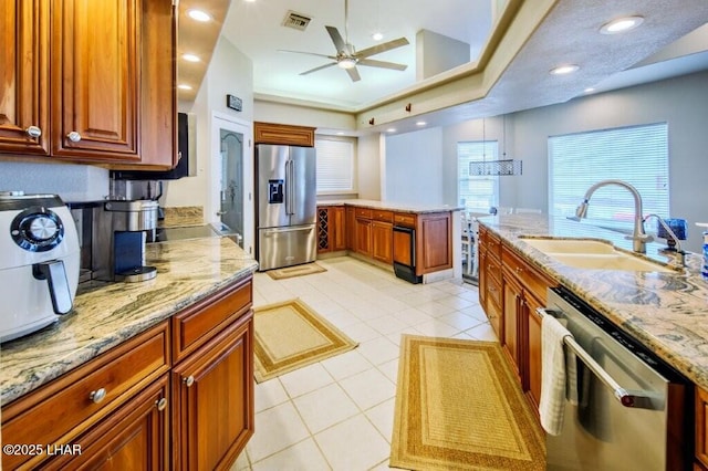 8839 Yaqui Loop, Parker, AZ 85344 - kitchen featuring stainless steel appliances, a sink, ceiling fan, light tile patterned flooring, and light stone counters