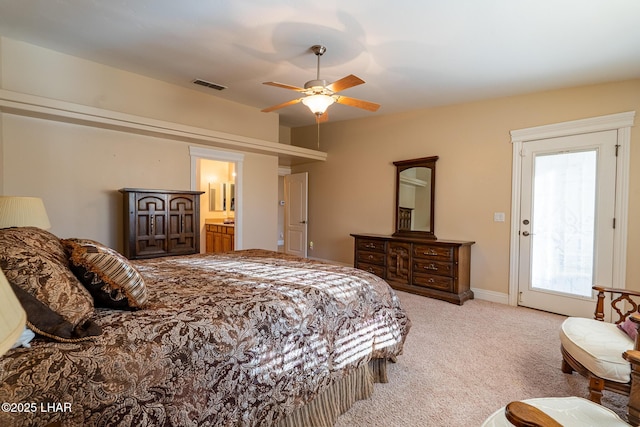 carpeted bedroom featuring ceiling fan and ensuite bath