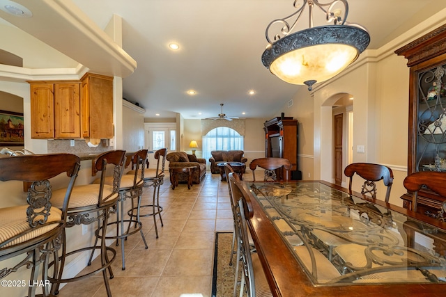 dining area with light tile patterned floors and ceiling fan