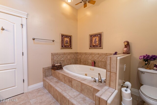 bathroom with tiled tub, tile patterned floors, ceiling fan, and toilet