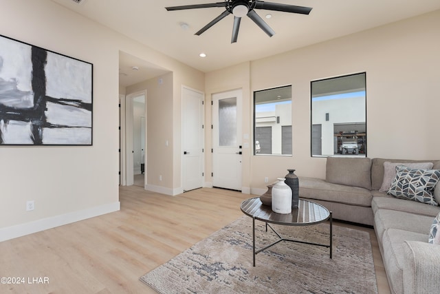 living room featuring light hardwood / wood-style flooring and ceiling fan