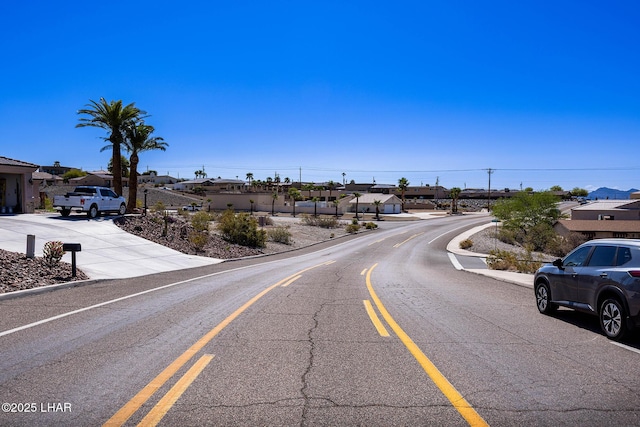 1216 Avalon Ave, Lake Havasu City, AZ 86404 - view of asphalt road featuring a residential view and curbs