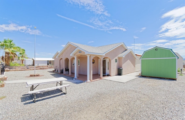 49605 Felspar Ave, Quartzsite, AZ 85346 - back of property with stucco siding and a patio