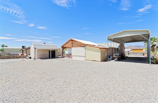 49605 Felspar Ave, Quartzsite, AZ 85346 - view of property exterior featuring a carport and an outbuilding
