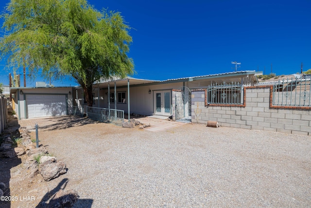 31447 Marine Dr, Parker, AZ 85344 - ranch-style house featuring a garage, driveway, french doors, and fence