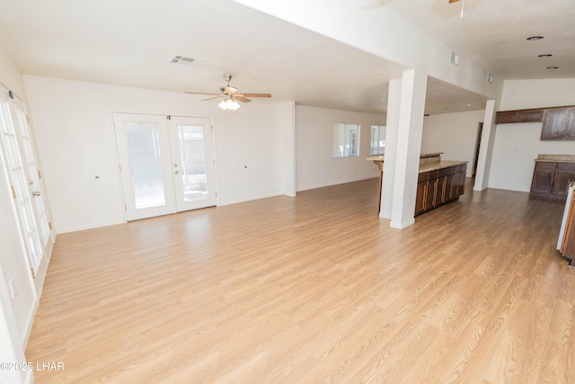 31447 Marine Dr, Parker, AZ 85344 - unfurnished living room featuring light wood-style flooring, visible vents, a ceiling fan, and french doors