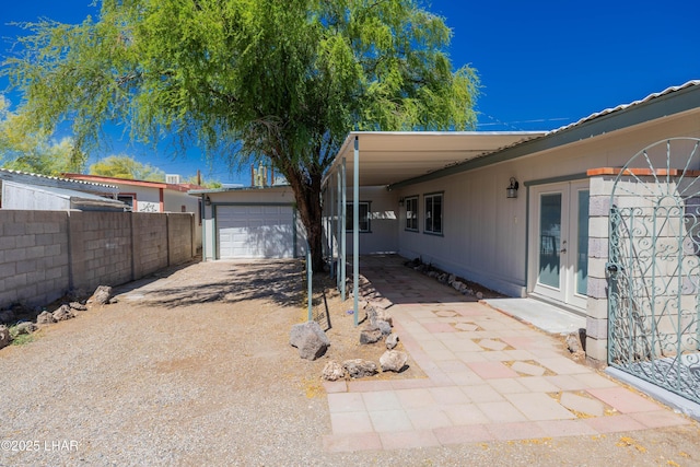31447 Marine Dr, Parker, AZ 85344 - view of patio / terrace with french doors, fence, a garage, and driveway