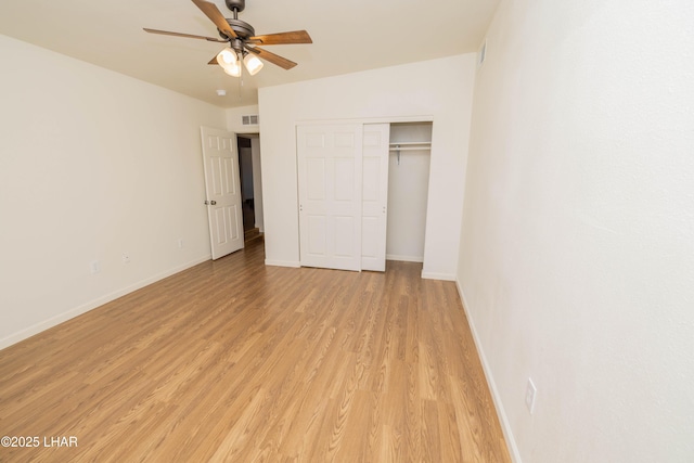 31447 Marine Dr, Parker, AZ 85344 - unfurnished bedroom with visible vents, a closet, baseboards, a ceiling fan, and light wood-style flooring