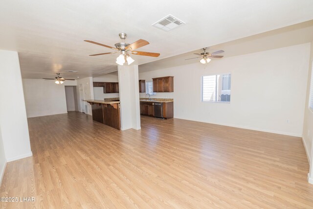 31447 Marine Dr, Parker, AZ 85344 - unfurnished living room featuring visible vents, light wood-style flooring, ceiling fan, and baseboards
