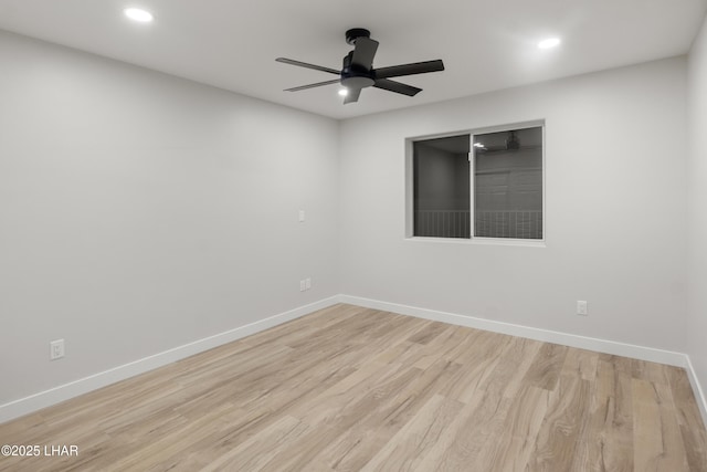 empty room featuring wood finished floors, a ceiling fan, and baseboards