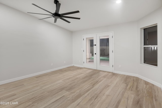 empty room with french doors, ceiling fan, light wood-style flooring, and baseboards