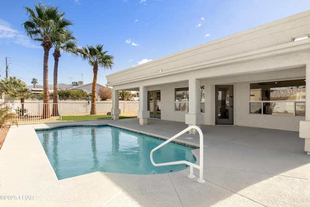 view of swimming pool with a patio area, fence, and a fenced in pool