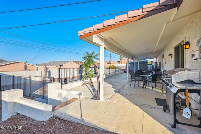 view of patio / terrace featuring a fenced backyard, a residential view, and a grill