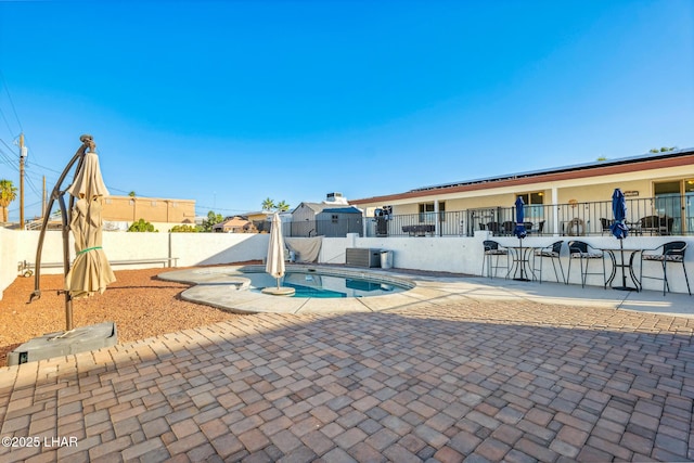 view of pool with a fenced backyard and a patio area