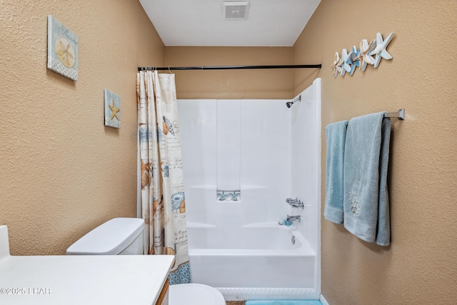 bathroom with shower / tub combo, toilet, a textured wall, and visible vents