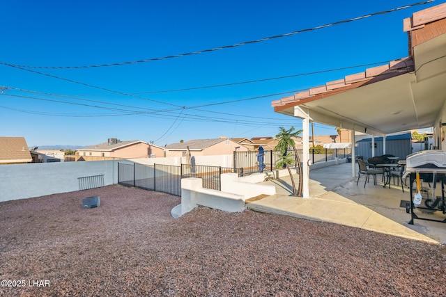 view of yard featuring a patio, fence private yard, and a residential view