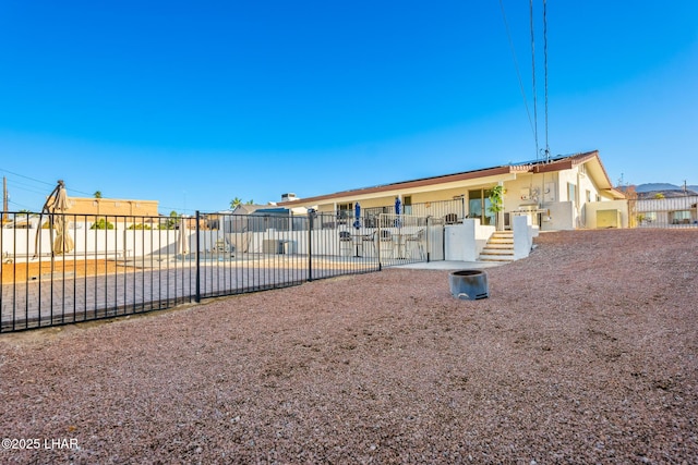 rear view of property with a patio area and fence