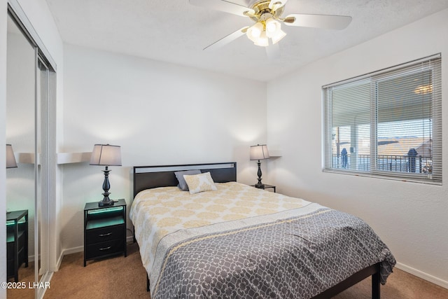 carpeted bedroom featuring a ceiling fan, baseboards, and a closet