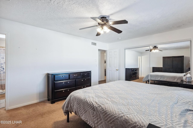 bedroom featuring visible vents, light carpet, a ceiling fan, a textured ceiling, and baseboards