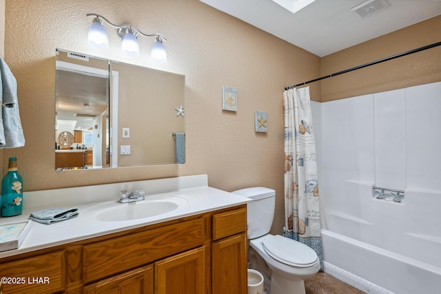 full bath featuring vanity, visible vents, a skylight, shower / bath combo with shower curtain, and toilet