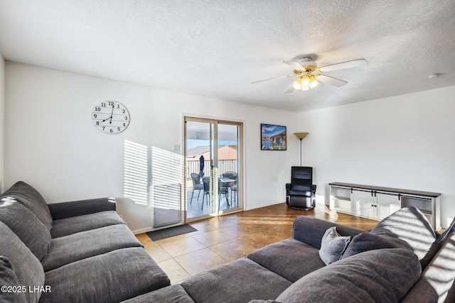 living room featuring tile patterned floors, a textured ceiling, and a ceiling fan