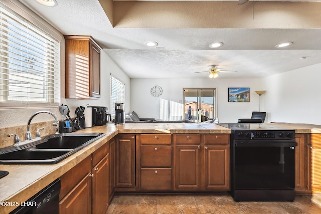 kitchen featuring recessed lighting, ceiling fan, a sink, black appliances, and a textured ceiling