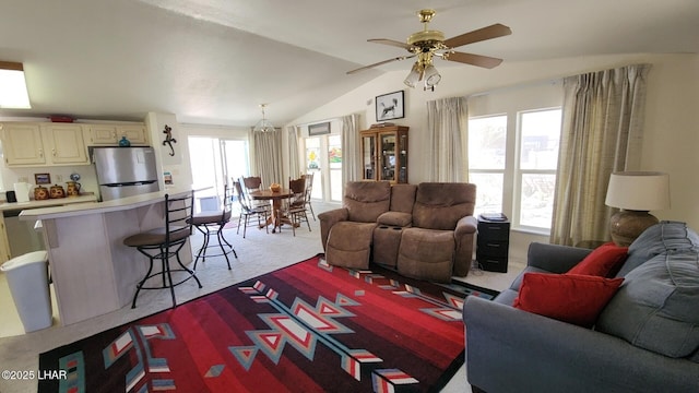 carpeted living area featuring lofted ceiling and a ceiling fan