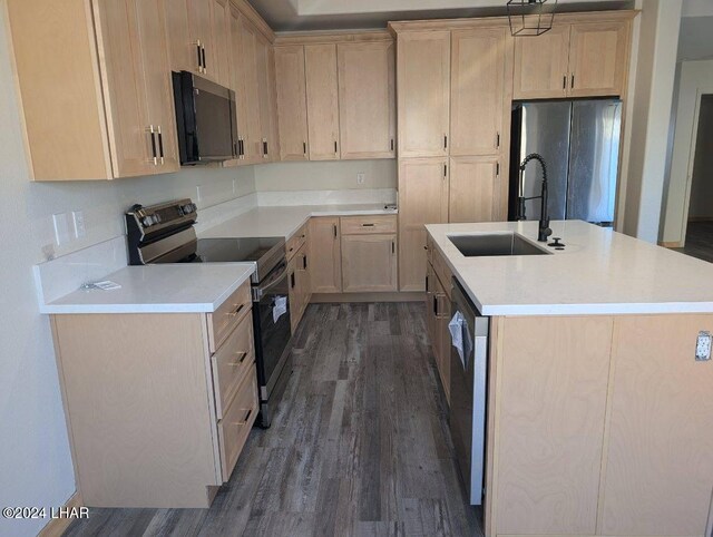 890 Florence Ave Unit 103, Bullhead City, AZ 86429 - kitchen with sink, dark hardwood / wood-style flooring, stainless steel appliances, an island with sink, and light brown cabinetry