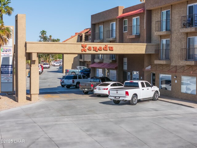 view of building exterior with uncovered parking