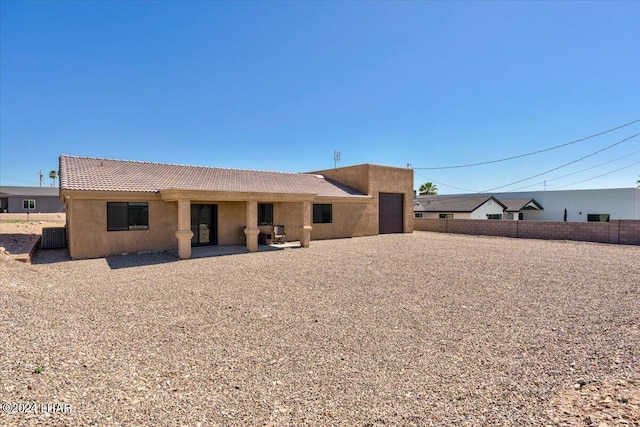 back of property with a patio