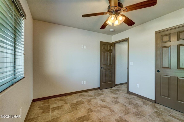 unfurnished bedroom featuring ceiling fan