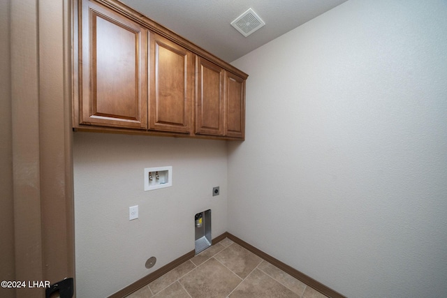 clothes washing area featuring cabinets, washer hookup, and hookup for an electric dryer