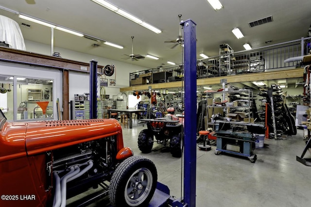 garage featuring visible vents, a workshop area, and ceiling fan