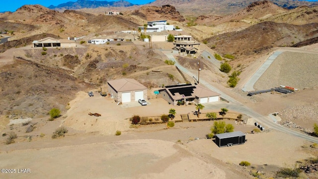 birds eye view of property featuring a mountain view and view of desert