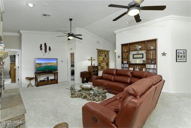 living room featuring visible vents, washer / clothes dryer, ornamental molding, vaulted ceiling, and light colored carpet