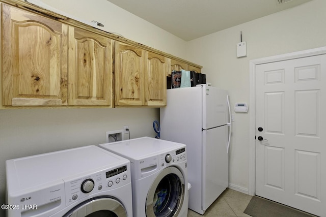 laundry area with cabinet space, light tile patterned floors, and separate washer and dryer