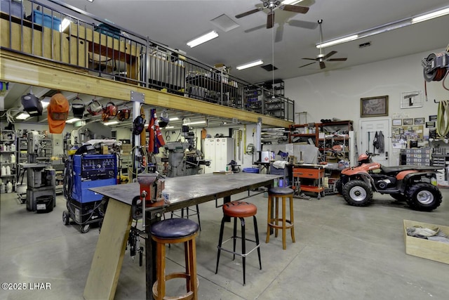 garage featuring a workshop area and ceiling fan