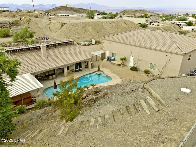 pool featuring a mountain view and a patio