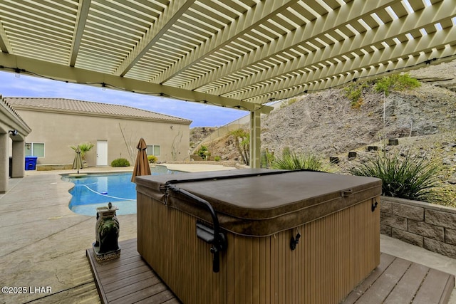 deck featuring an outdoor pool and a hot tub