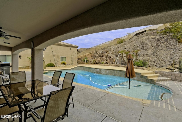 pool featuring outdoor dining area, a patio area, fence, and ceiling fan