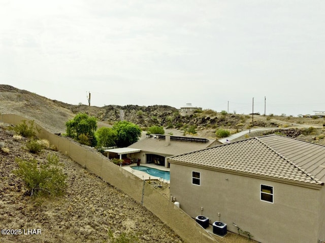 exterior space featuring a fenced in pool, central AC, and a fenced backyard