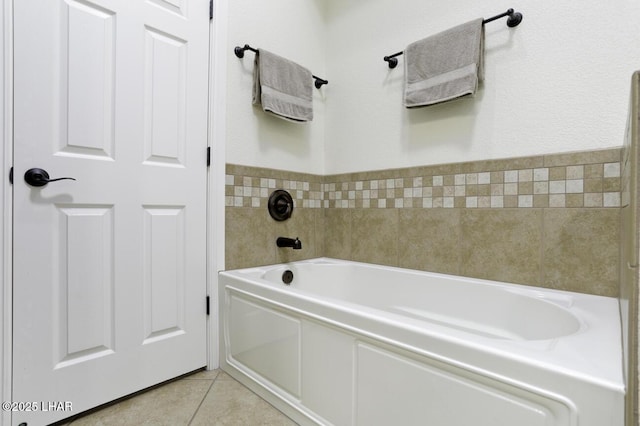 full bathroom featuring tile patterned floors and a garden tub