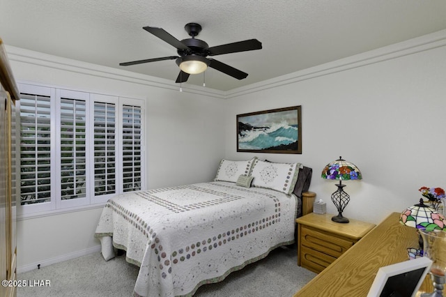 carpeted bedroom with a textured ceiling, baseboards, and ceiling fan